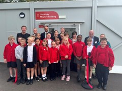 Vicky McClure and Jonny Owen are standing outside the Vicky McClure building with pupils, school govenors and partners.