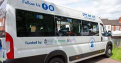A side image of the new minibus with all the sponsors logos on display  