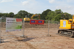 A banner at the Kirk Hill junction next to a digger