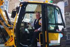 Council Leader, Cllr Mick Barton, inside the cab of a Pothole Pro machine 