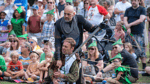 An action shot from a combat show from a previous event celebrating Notts Day. In the crowd are people wearing Robin Hood hats