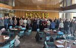 A group photo of volunteers attending a Community Flood Signage Scheme training session.  Gold balloons spell out CFSS 18 as it is the 18th training session.