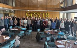 A group photo of volunteers attending a Community Flood Signage Scheme training session.  Gold balloons spell out CFSS 18 as it is the 18th training session.