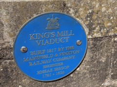 A blue plaque on a stone wall with the words King's Mill Viaduct.