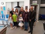 Adults and young people celebrate youth service young carer friendly award