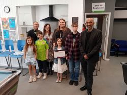 Adults and young people celebrate youth service young carer friendly award