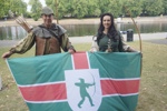 Robin Hood and Maid Marian pictured with the Nottinghamshire flag on the banks of the River Trent.