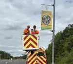 Fostering lamppost banner installation