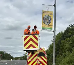 Fostering lamppost banner installation