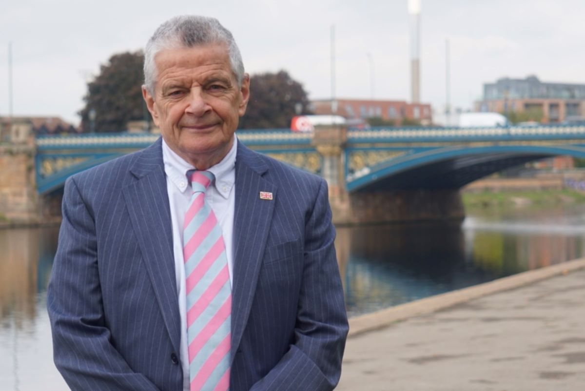 Cllr Bert Bingham standing outside County Hall with Trent Bridge in the background alongside river Trent 