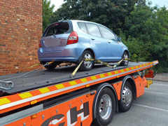 Car containing on a recovery vehicle 