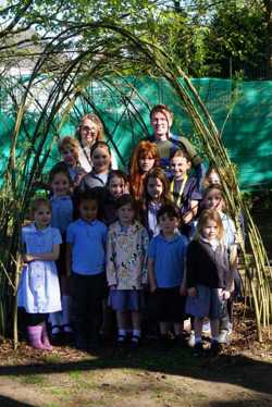 Pictured is Cllr James Gamble, back right, and St Mary's CofE School headteacher, Jennie Bailey, with pupils under the living willow tunnel.