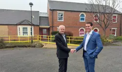 Councillors shaking hands on a housing estate