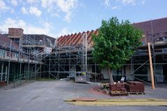 school building covered in scaffolding 
