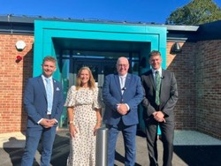 Councillors and the team leader of the family time service are standing outside the new Harmony House building 