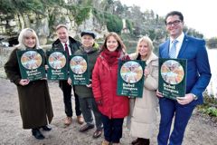 Representatives of partner organisations are gathering at Creswell Crags. All are holding up plaques which have the rebel rangers branding on them